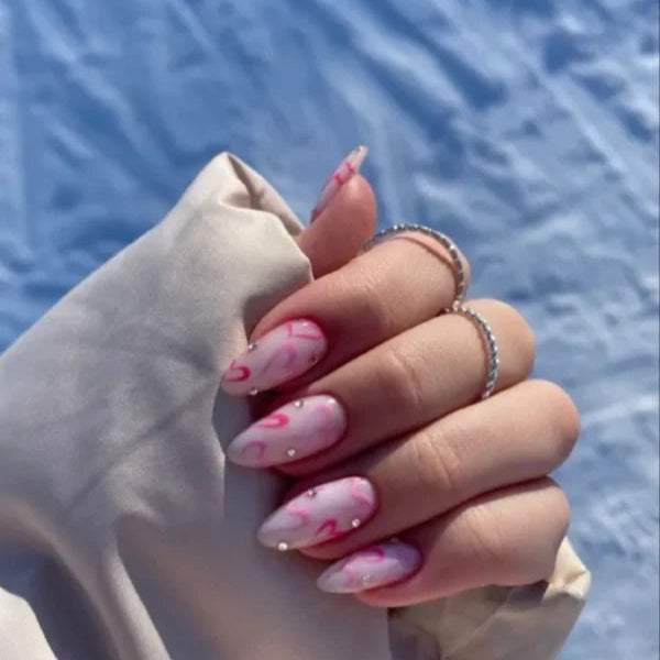 Pink hearts and rhinestones nails