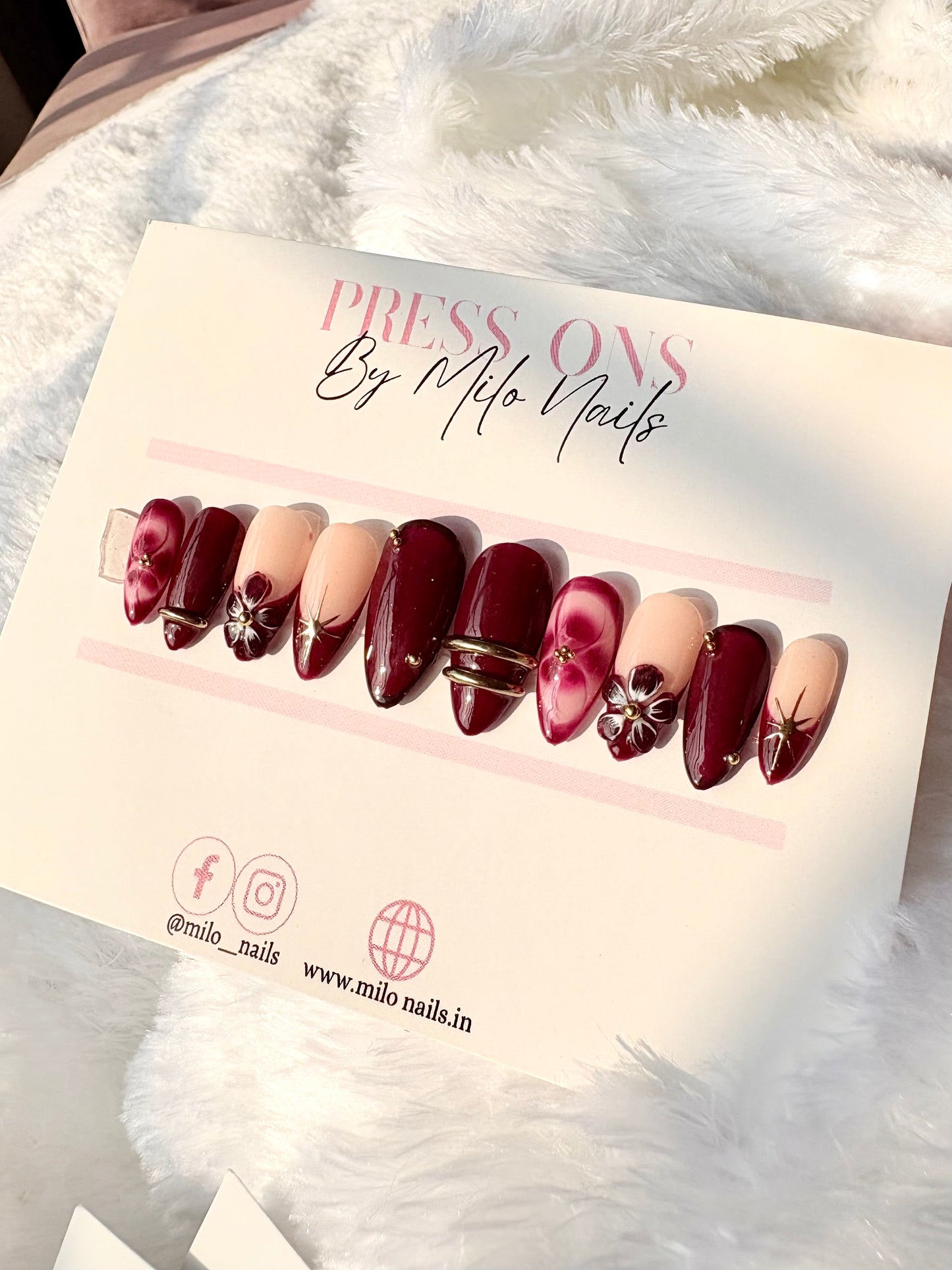 Maroon flower with printed nails