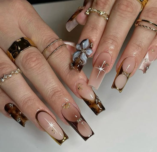 Brown cross intricate nails